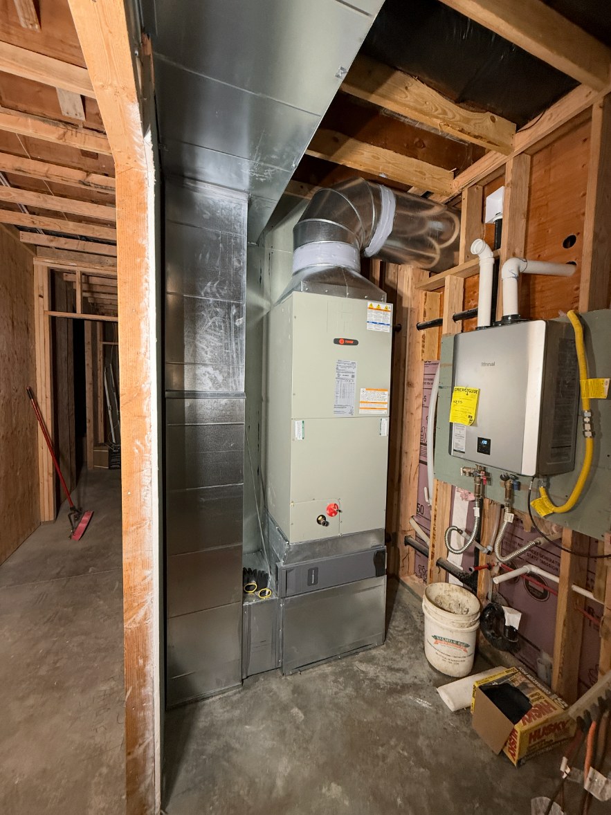 Trane furnace installed next to a tankless water heater