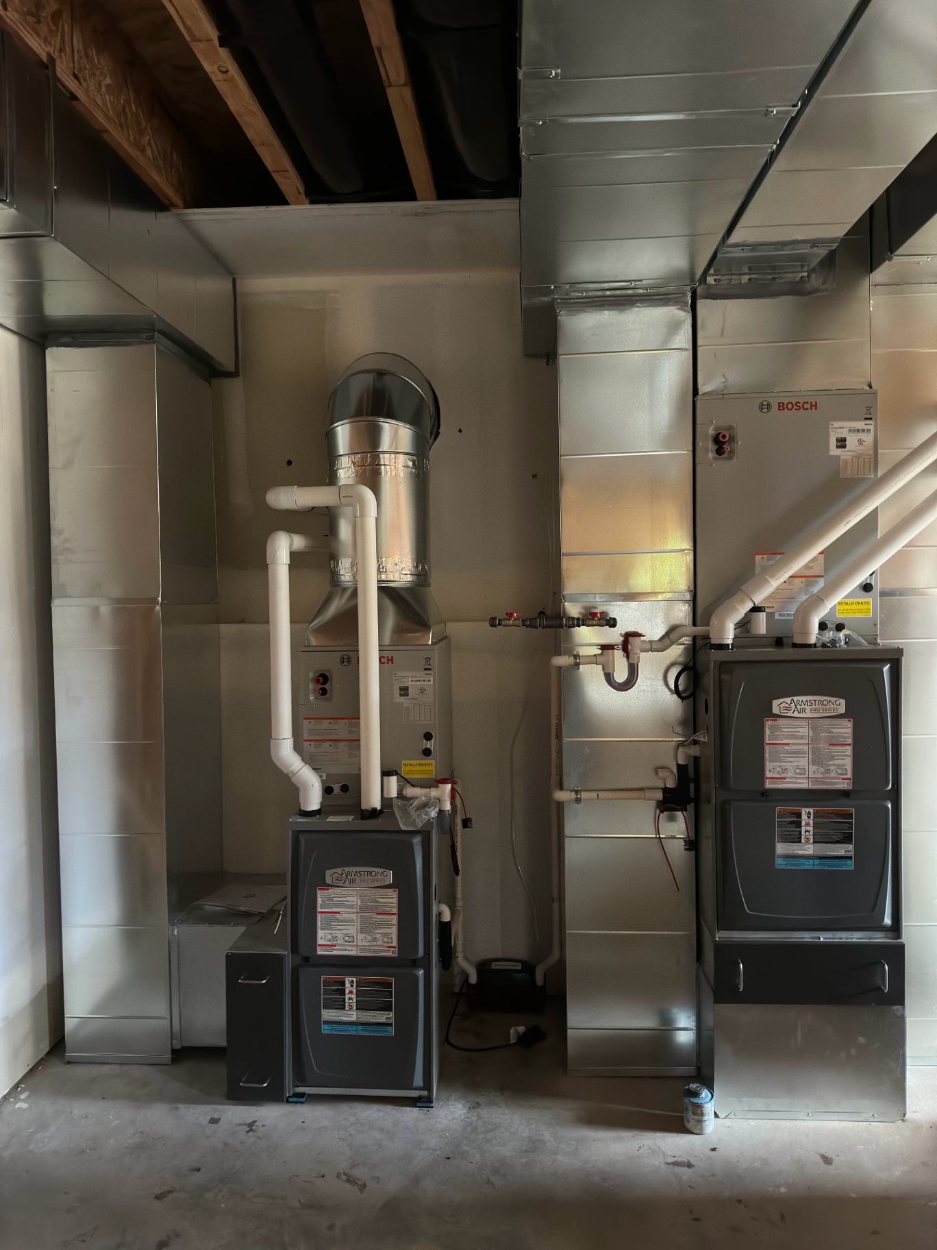 Two Armstrong Air furnaces with custom sheet metal ductwork
